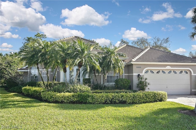 view of front facade with a front yard and a garage