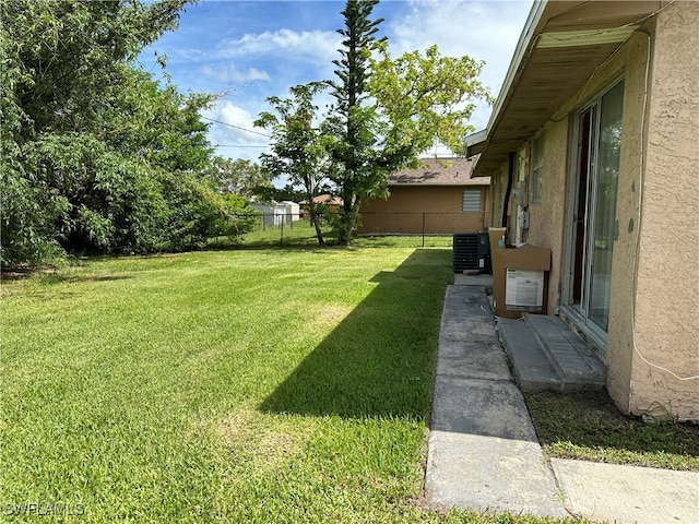 view of yard featuring central air condition unit