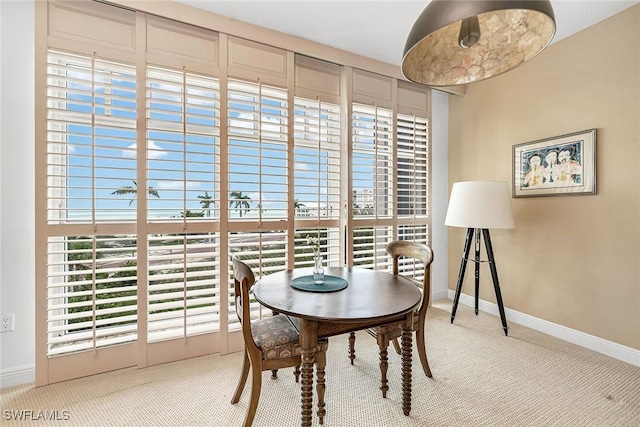 dining space featuring carpet floors and baseboards