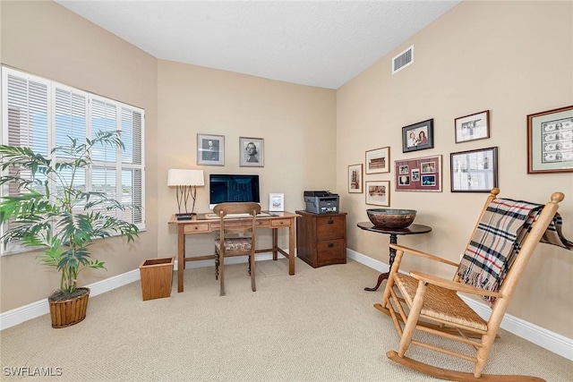 carpeted office space with baseboards and visible vents