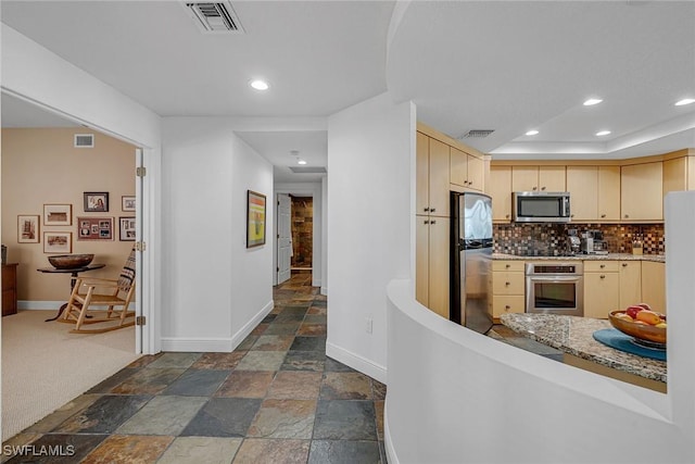 kitchen featuring baseboards, appliances with stainless steel finishes, and visible vents