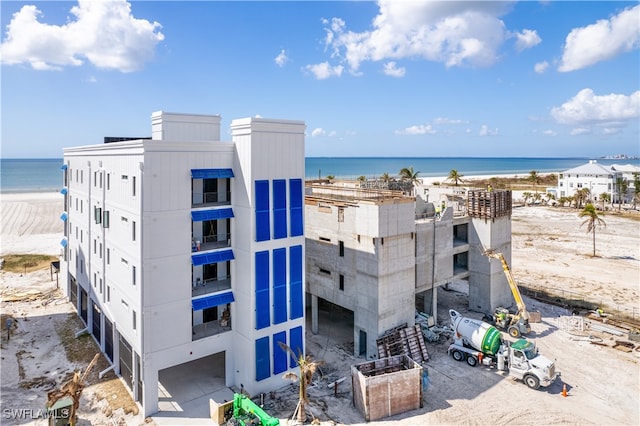 exterior space featuring a water view and a beach view