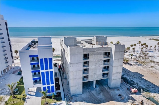 view of building exterior with a view of the beach and a water view