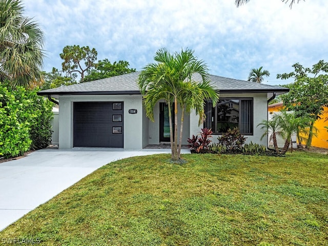 view of front of house featuring a garage and a front lawn