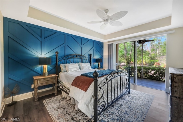 bedroom featuring access to exterior, ceiling fan, baseboards, and dark wood-type flooring