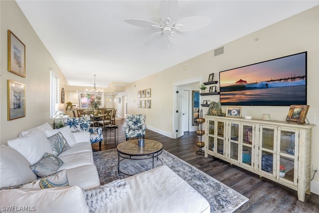 living room with visible vents, baseboards, dark wood-type flooring, and ceiling fan with notable chandelier