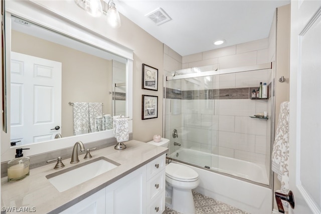 bathroom with toilet, bath / shower combo with glass door, vanity, and visible vents