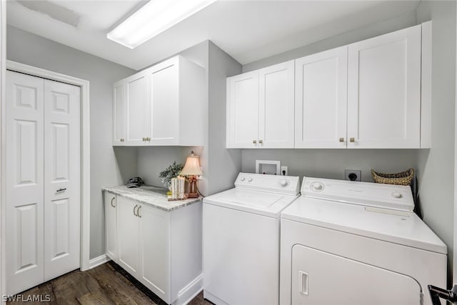 washroom with cabinet space, dark wood-style floors, and washing machine and clothes dryer