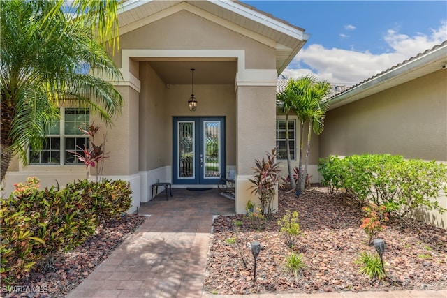 view of exterior entry featuring french doors