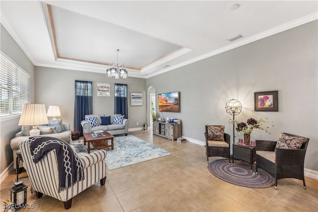 living room with a raised ceiling, light tile patterned floors, ornamental molding, and a chandelier