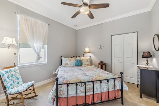 carpeted bedroom featuring ceiling fan, ornamental molding, and a closet