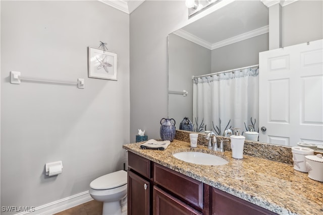 bathroom featuring tile patterned flooring, vanity, toilet, and crown molding