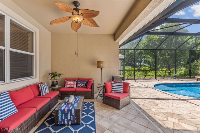 view of patio / terrace with outdoor lounge area, ceiling fan, and glass enclosure