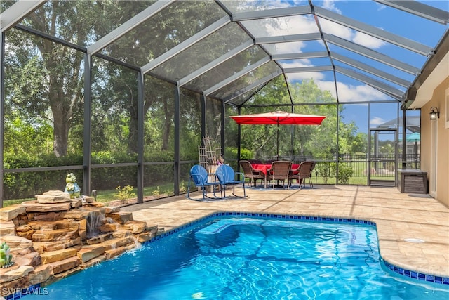 view of pool with a patio area and a lanai