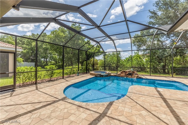 view of swimming pool featuring an in ground hot tub, glass enclosure, and a patio area