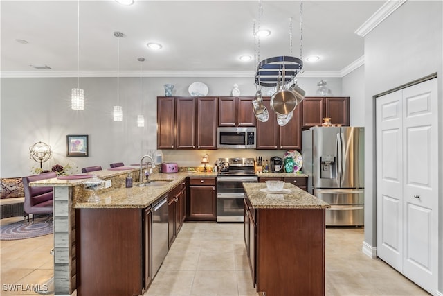 kitchen featuring kitchen peninsula, appliances with stainless steel finishes, crown molding, pendant lighting, and light tile patterned flooring