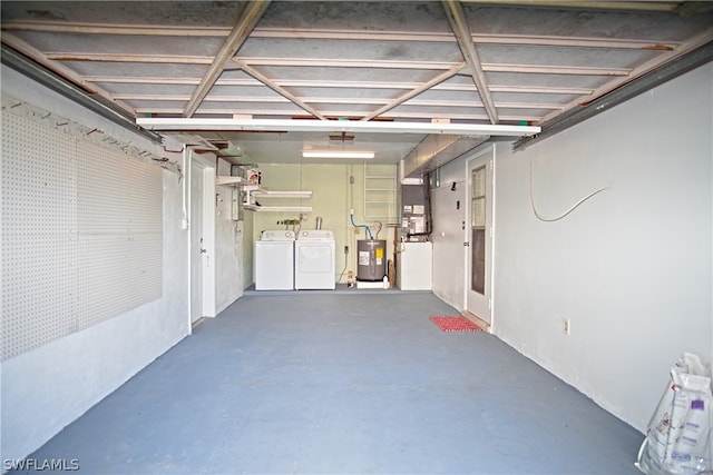 garage featuring washer and dryer and electric water heater