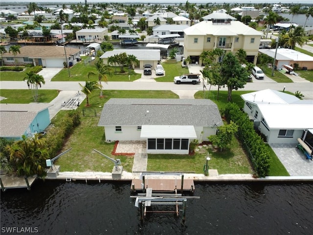 birds eye view of property with a water view and a residential view