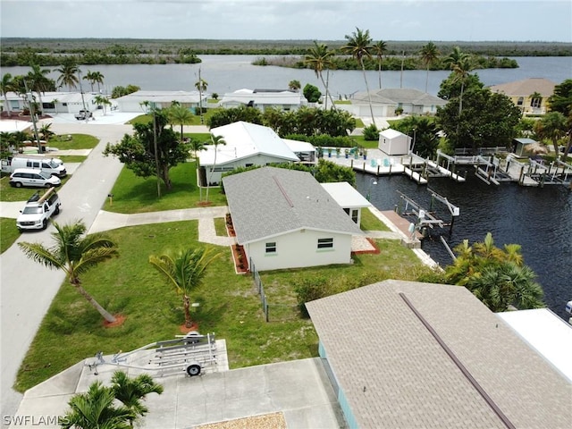 drone / aerial view featuring a residential view and a water view