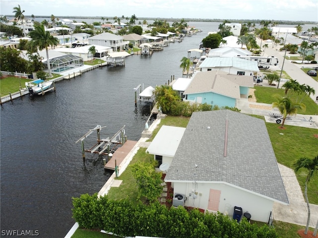 drone / aerial view featuring a water view and a residential view