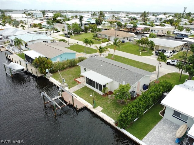 drone / aerial view with a water view and a residential view