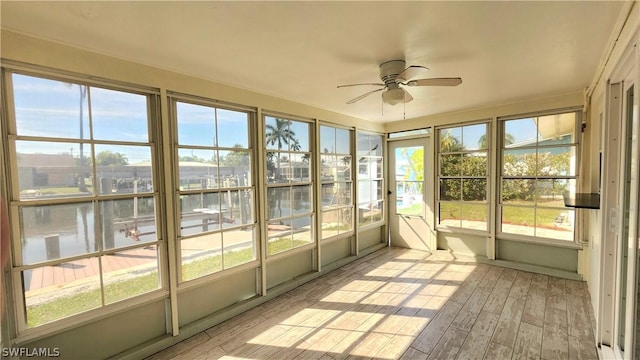 unfurnished sunroom with a ceiling fan