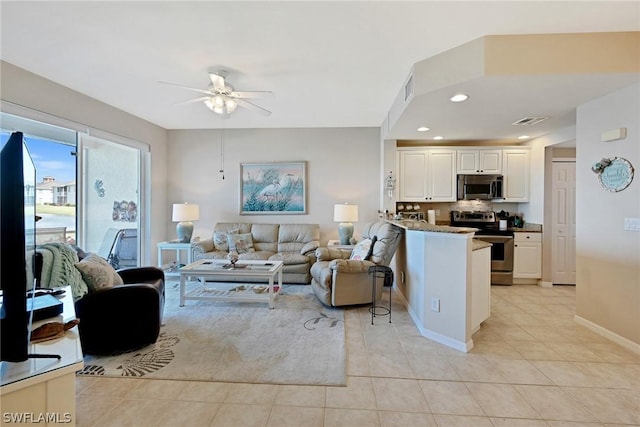 living room featuring ceiling fan and light tile patterned floors