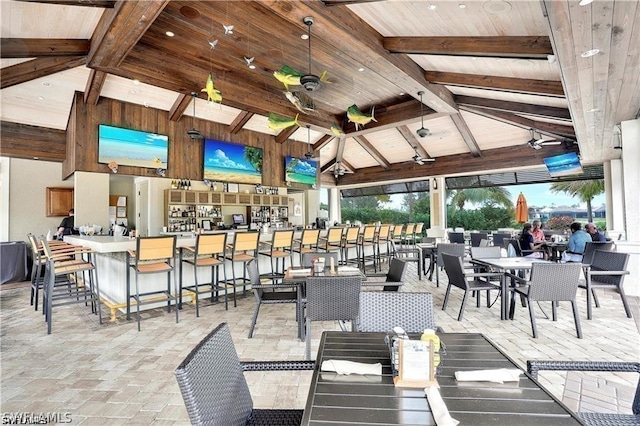 exterior space with wood ceiling, high vaulted ceiling, and beamed ceiling