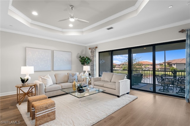 living room with ceiling fan, hardwood / wood-style flooring, and ornamental molding