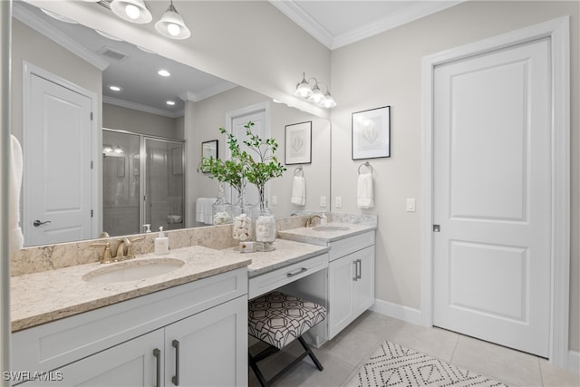 bathroom with a shower with door, vanity, crown molding, and tile patterned flooring