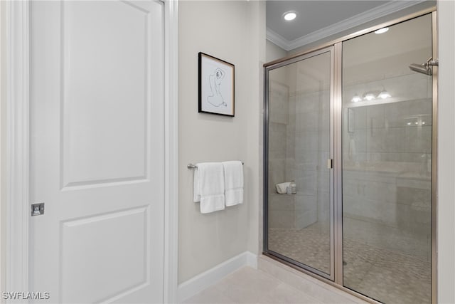 bathroom with a shower with door, tile patterned floors, and crown molding