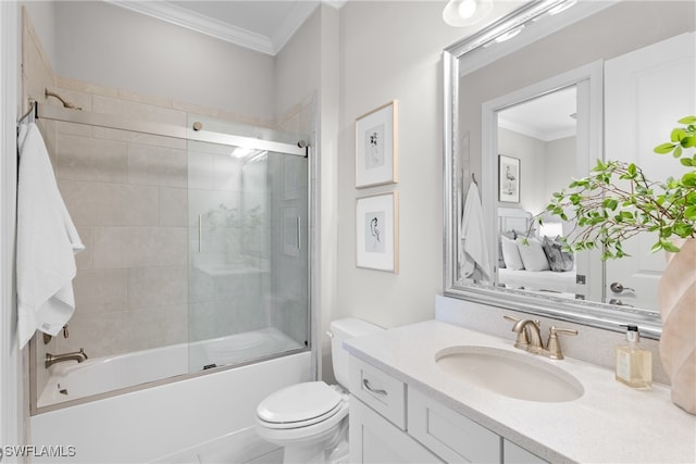 full bathroom with vanity, toilet, crown molding, and shower / bath combination with glass door