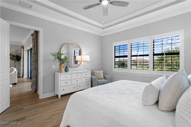 bedroom with ceiling fan, crown molding, and hardwood / wood-style floors