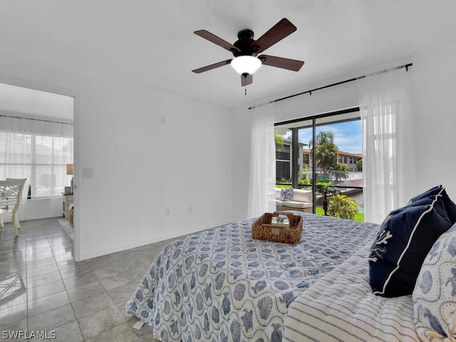 bedroom featuring access to exterior, ceiling fan, and light tile patterned flooring