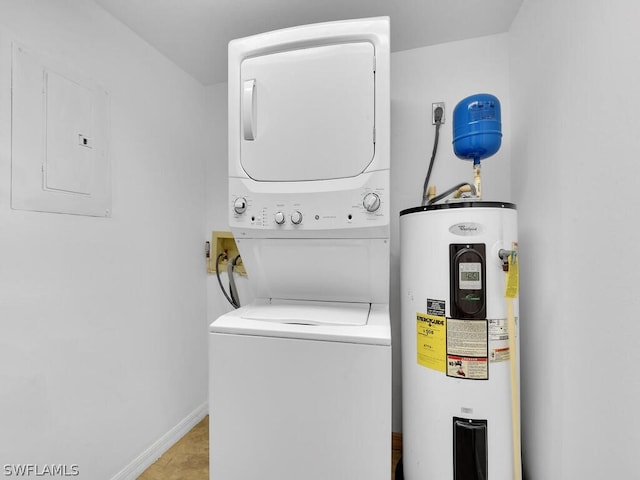 clothes washing area with stacked washer / drying machine, electric panel, and water heater