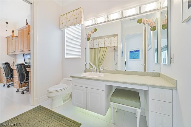 bathroom featuring toilet, vanity, a shower, and tile patterned floors