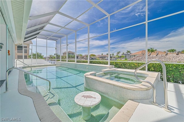 view of pool with glass enclosure and a pool with connected hot tub