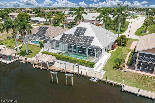 birds eye view of property with a water view and a residential view