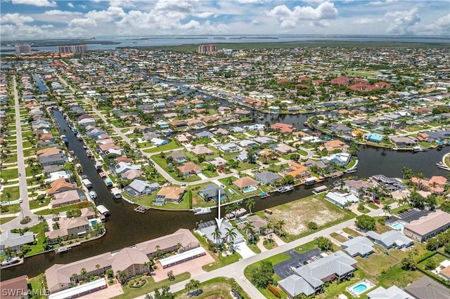 birds eye view of property with a residential view and a water view