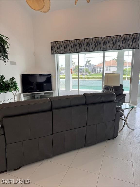 living room with a wealth of natural light and light tile patterned flooring