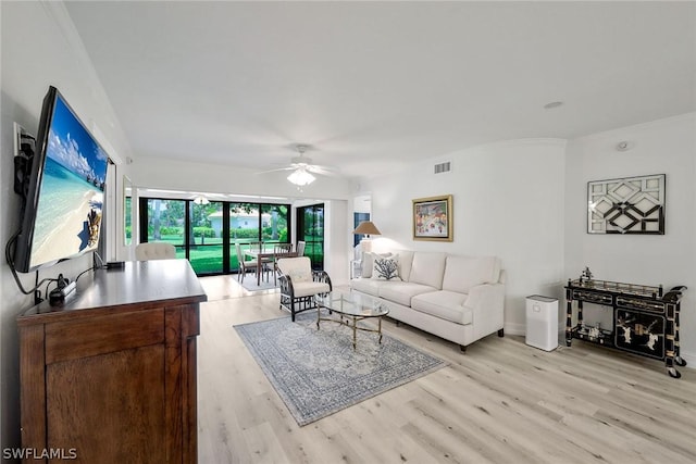 living room with ceiling fan and light hardwood / wood-style flooring