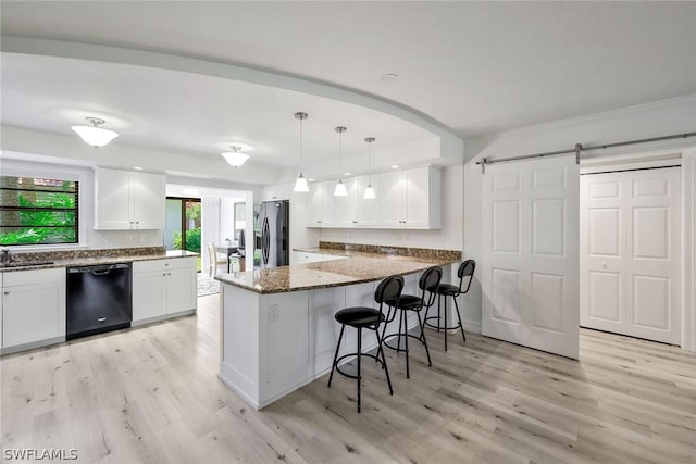 kitchen featuring white cabinets, stainless steel refrigerator with ice dispenser, a barn door, black dishwasher, and kitchen peninsula