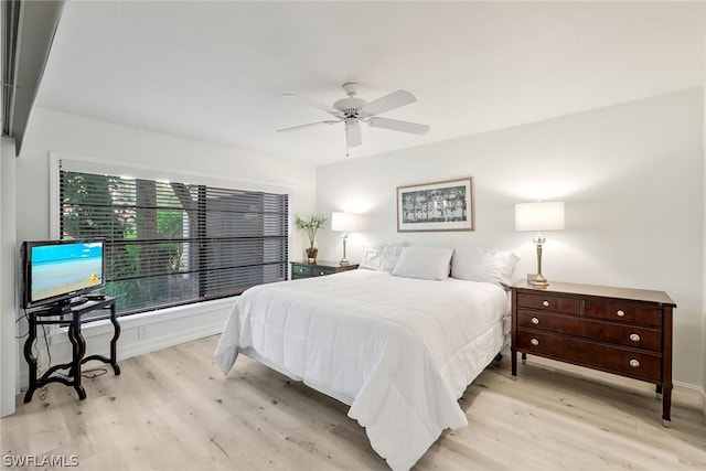 bedroom with ceiling fan and light hardwood / wood-style flooring