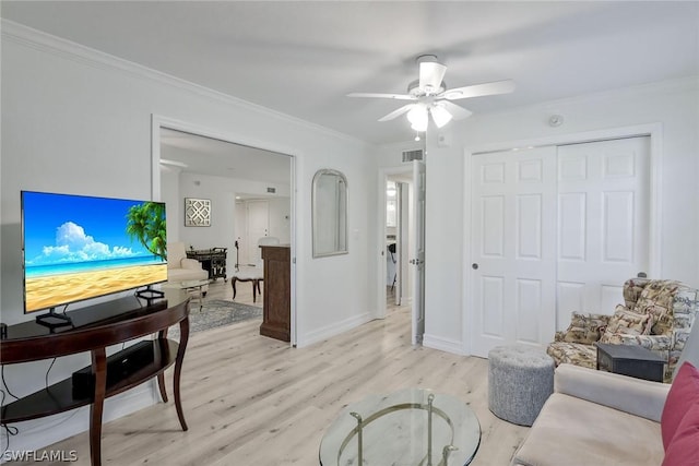 living room with ceiling fan, light hardwood / wood-style floors, and ornamental molding