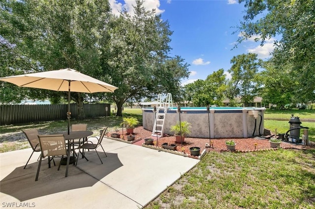 view of patio / terrace with a fenced in pool