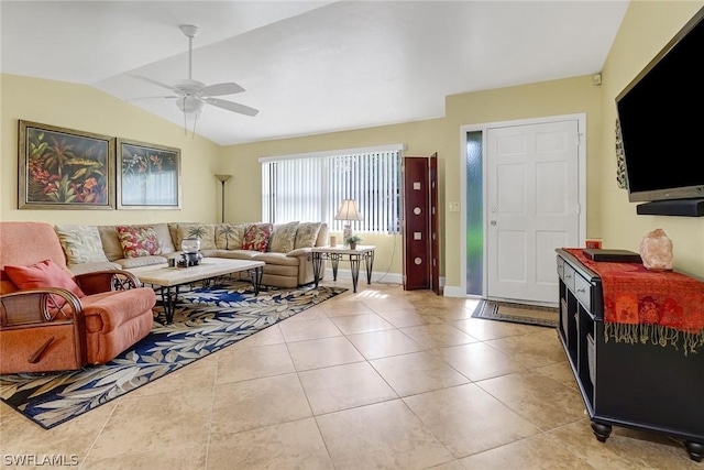 living area with light tile patterned floors, a ceiling fan, lofted ceiling, and baseboards