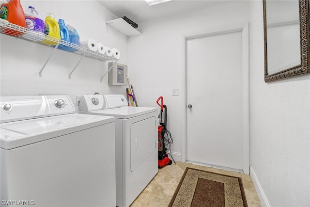 laundry area featuring washer and clothes dryer and light tile floors