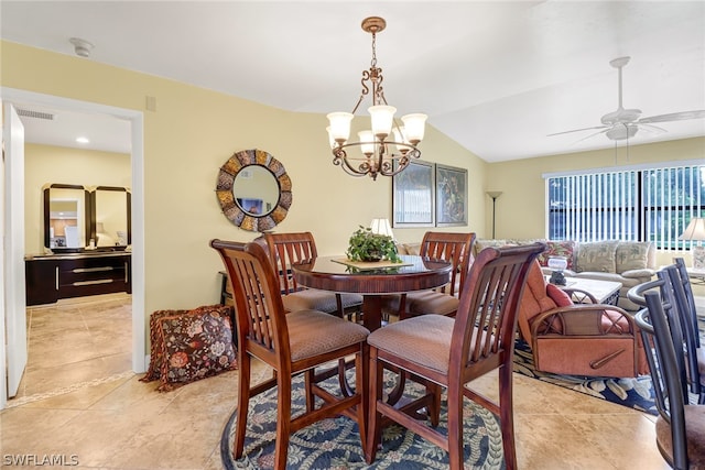 tiled dining area with vaulted ceiling and ceiling fan with notable chandelier