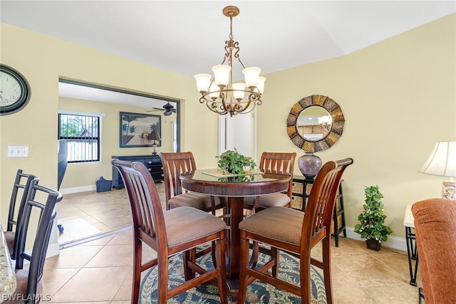 dining space featuring a notable chandelier and light tile floors