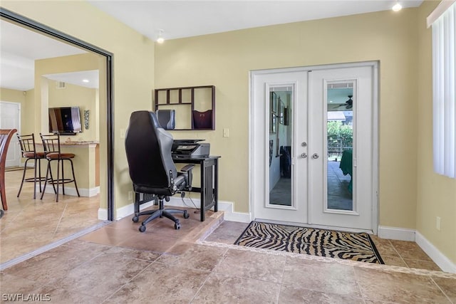 home office with baseboards, stone finish floor, and french doors